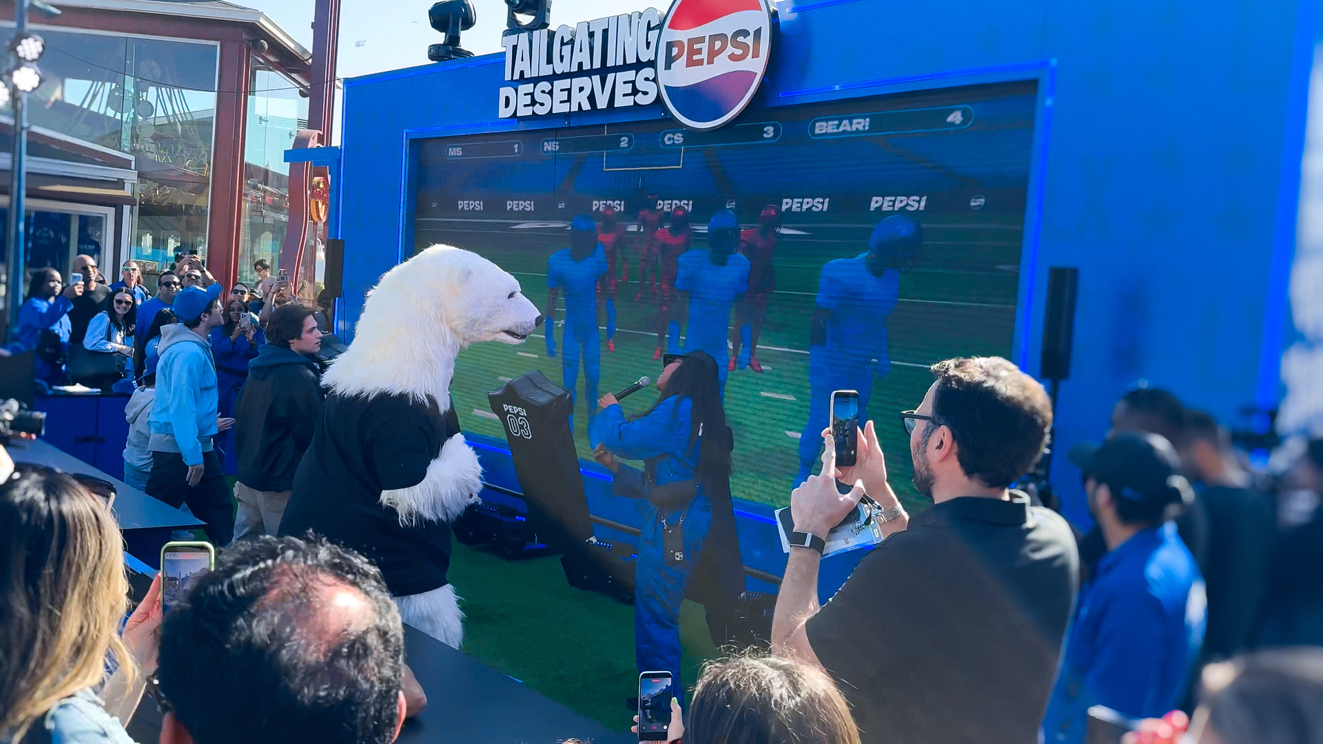 Pepsi interactive football game installation at Super Bowl LX brand activation, participants playing